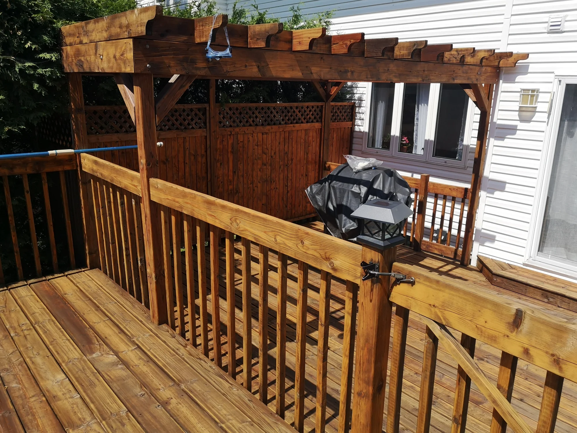 Pergola et garde-corps en bois teinté.